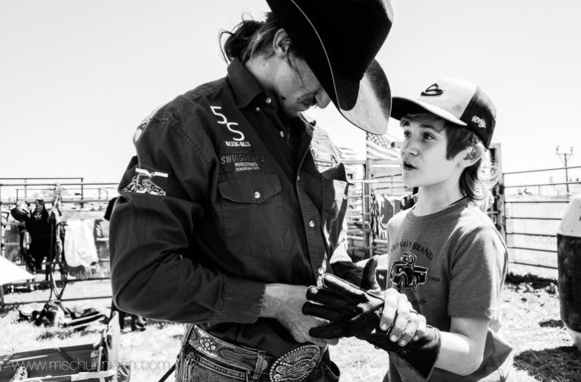 Professional bull rider Ernie Courson Jr. is pictured with his oldest son Trenton.